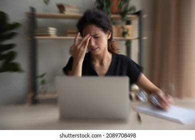 Unhealthy Hispanic Woman Work On Laptop At Home Office Struggle With Blurry Vision Or Dizziness. Unhappy Sick Latino Female Have Migraine Or Headache Overwhelmed With Computer Job. Overwork Concept.