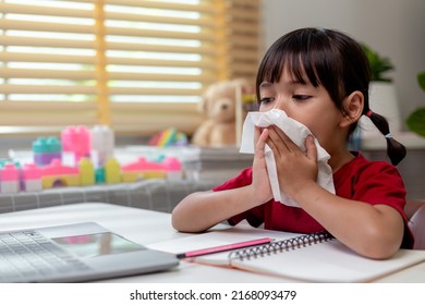 Unhealthy Kid Blowing Nose Into Tissue, Child Suffering From Running Nose Or Sneezing, A Girl Catches A Cold When Season Change, Childhood Wiping Nose With Tissue