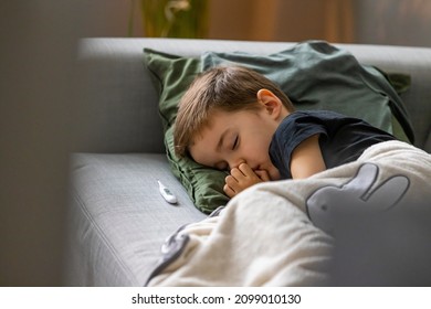 Unhealthy Little Boy Child Measure High Temperature With Thermometer Sleep In Bed Relax At Home In Bedroom. Sick Ill Little Kid Suffer From Flu Fever Asleep In Bed On Lockdown Quarantine.