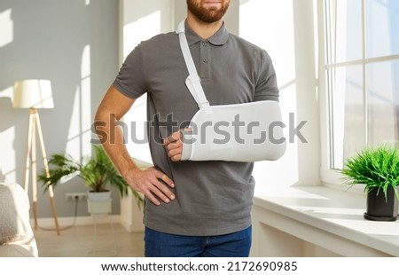 Unhealthy man have protective bandage on broken hand have rehabilitation after accident or trauma. Unwell guy with splint or sling on injured arm. Injury and rehab. Health insurance and healthcare.