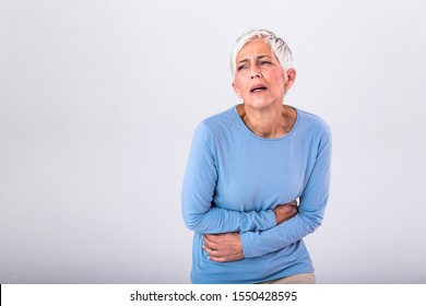 Unhealthy Mature Woman Holding Belly, Feeling Discomfort, Health Problem Concept, Unhappy Older Female Sitting On Bed, Suffering From Stomachache, Food Poisoning, Gastritis, Abdominal Pain, Climax