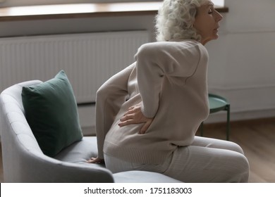 Unhealthy Older Woman Stand Up From Chair Touch Back Suffer From Spinal Spasm Or Strain, Sick Mature Female Struggle With Arthritis Radiculitis, Having Backache Or Painful Feeling, Eldercare Concept