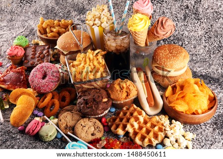 Unhealthy products. food bad for figure, skin, heart and teeth. Assortment of fast carbohydrates food with fries and cola
