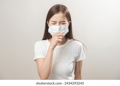 Unhealthy sickness, unwell asian young woman wearing mask coughing, have sore throat, suffering symptom cough feeling bad and healthcare of air pollution and dust, PM2.5 isolated white background. - Powered by Shutterstock