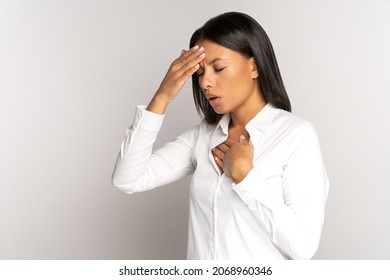 Unhealthy woman suffer from shortness of breath, pneumonia or respiratory disease, covid-19 in fever touching forehead and chest. Young female feel fatigue, asthma attack or dyspnea after coronavirus