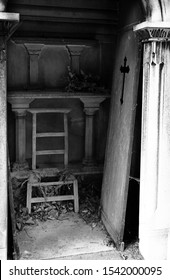 Unhinged Door And Broken Chair On Burial Plot Of The Cemetery