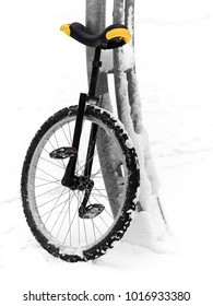 Unicycle Stand At The Pillar On Playground In Snow Winter Day