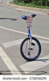 Unicycle Standing On A Stand With A Sign Parking For Unicycles Only