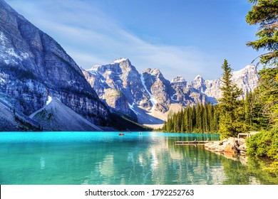 Unidentifiable visitors canoeing their boats on turquoise-colored Moraine Lake in the Canadian Rockies of Banff National Park near Lake Louise. The Valley of the Ten Peaks in the background. - Powered by Shutterstock