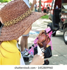 Unidentifiable Woman Eating A Turkey Leg At Local Festival In Denver. 