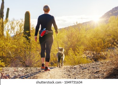 Unidentifiable Woman Walking A Dog On A Hiking Path In Mountain View Park In Phoenix, Arizona