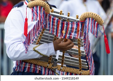 Unidentifiable Young Woman Playing Xylophone During Panama National Day Parade Celebrating The Separation Of Panama From Colombia. Selective Focus.