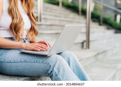 Unidentifiable Young Woman Using Computer Outdoor Remote Working On Small Business 