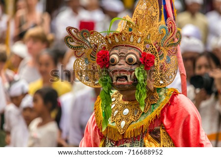 Unidentified balinese people performing in traditional masks during Galungan celebration in Ubud, Bali