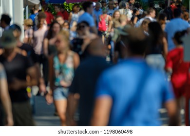 Unidentified crowd of people walking on the street at sunny day time