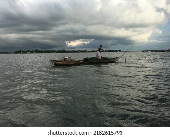 An Unidentified Fisherman Controlling His Boat Agains The Storm Inside The Big River. City: Sonargaon, Country: Bangladesh. Date: July 24, 2020.