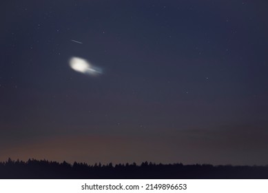 An unidentified flying object in the evening sky. - Shutterstock ID 2149896653