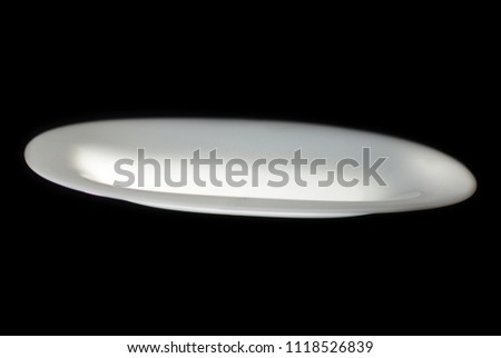 Unidentified Flying Plate. Isolated on a black background