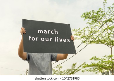 Unidentified Hold A Placard With Text March For Our Lives. 