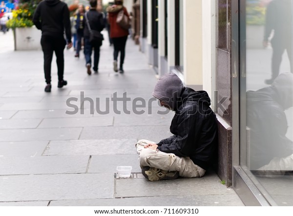 An unidentified homeless man begging on city\
street in Glasgow, Scotland.