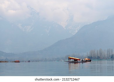 An unidentified man rowing a Shikara(Shikhara) boat on the Dal Lake on a winter morning at Srinagar, Jammu and Kashmir.