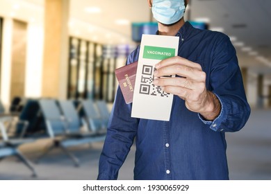 unidentified manwearing a face mask and holding a passport and a Green pass certificate of vaccination.The European Union will propose issuing a certificate called a Digital Green Pass