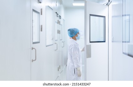 Unidentified Microbiologist Is Open The Cleanroom Door To Enter The Room In Clean Area Of Microbial Laboratory In Pharmaceutical Factory, Concept Of Science, Healthcare And Safety Operation.