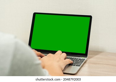 Unidentified people working with laptop, typing something on green screen. - Powered by Shutterstock