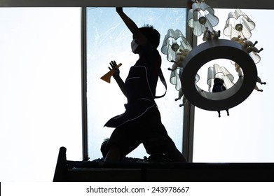 Unidentified  People Wrappers Tinting A Glass House Window With A Tinted Foil In Silhouette