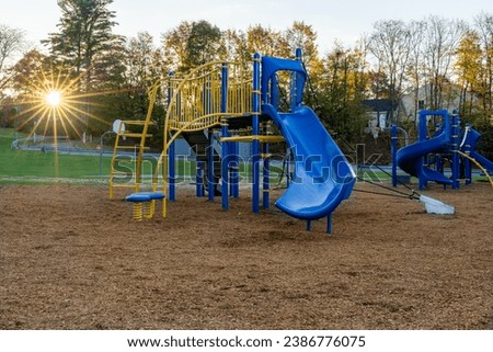 Unidentified typical elementary school playground with engineered wood fiber safety fall surface	