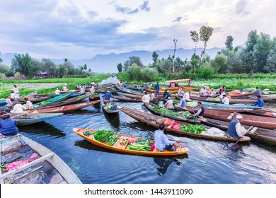 Unidentified vegetable vendors sell their produce on their boat  at floating vegetable market - Dal Lake, Sri Nagar, India on June 26, 2018 