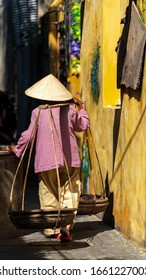 Unidentified Vietnamese Merchant Wearing Traditional Vietnamese Conical Hat At Hoi An.