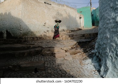 An Unidentified woman walking on the colorful streets in the old city of Harar, Ethiopia