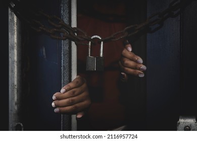 Unidentified woman's hand trapped in an illegally smuggled container locked with chain and key. Efforts to escape from the confinement were tortured : Human Trafficking and Illegal Immigration. - Shutterstock ID 2116957724