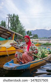 unidentified women sailing  boat to reach  home in Dal Lake, Jammu and kashmir, India  on June 25, 2018