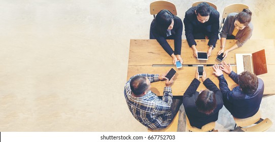 Unified Collaboration Marketing Team Collaborate In Office Meeting. Group Of People Using Smartphone Working Sales Team. Marketing Communications Strategy In Business Office. Banner With Copy Space.