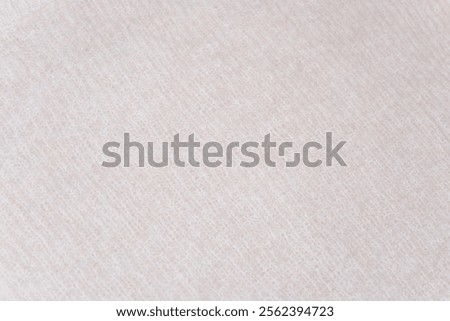 Uniform beige texture: A flat surface of beige wool fabric with no visible knit pattern. Beige wool fabric. The minimalist material looks soft and versatile, evoking simplicity and comfort.