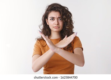 Unimpressed disappointed attractive armenian girlfriend curly hair frowning upset make cross arms show no never stop enough gesture make prohibition forbidden sign, declining offer