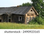 uninhabited abandoned houses in old villages from the times of collective farms and collectivization in the Soviet Union. 1930-1940-1950 of the last century, surrounded by forests and fields