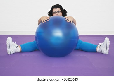 Uninspired Overweight Woman Sitting Behind Exercise Ball