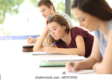 Uninterested Student Drawing During A Class In A Classroom