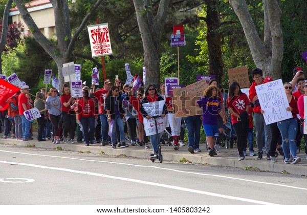 Union City, CA - May 22, 2019: Teachers and\
students march to the New Haven School District Educational\
Services Center to protest. 1st teachers strike ever at New Haven\
Unified’s schools.