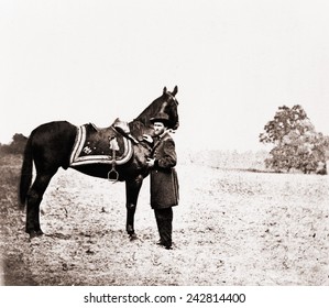 Union general Ulysses S. Grant (1822-1885), standing alongside his war horse, Cincinnati. June 4, 1864.
