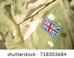 Union Jack / Union flag badge on a British army camouflage uniform. Potential text / writing / copy space around badge.