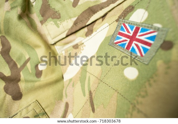 Union\
Jack / Union flag badge on a British army camouflage uniform.\
Potential text / writing / copy space around\
badge.