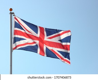 Union Jack Flag Blowing In The Wind On Flag Pole