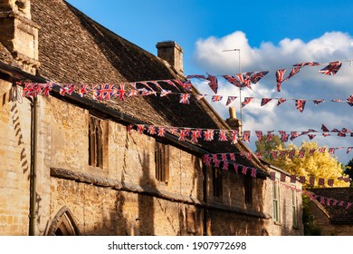 Union Jack flag bunting hanging in a street, a festive decorations in Southwest England, UK - Shutterstock ID 1907972698