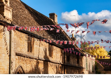 Union Jack flag bunting hanging in a street, a festive decorations in Southwest England, UK