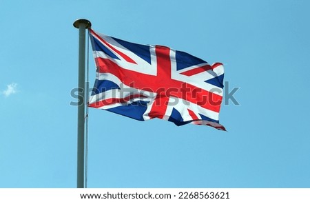 The Union jack flag of Great Britain fluttering in the breeze.