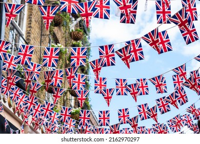 Union Jack flags on the street during queens jubilee celebration. Street party decorations in the UK city. Selective focus 